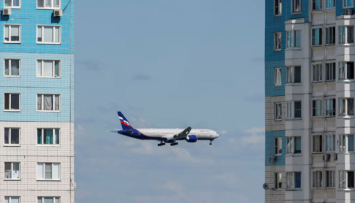 An Aeroflot passenger aircraft flies past multi-storey apartment blocks before landing at Sheremetyevo International Airport, on the outskirts of Moscow, Russia, July 24, 2024. — Reuters