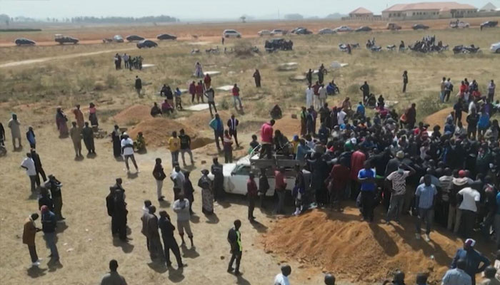 Families bury their close ones in a mass grave in the village of Maiyanga in Central Nigeria on December 27, 2023.—AFP