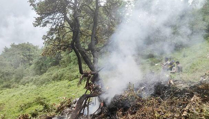 This handout photograph taken on June 15, 2025 and released by the State Disaster Response Force (SDRF) of Indias Uttarakhand state shows smoke billowing from the site of a chopper crash near Gaurikund. —AFP