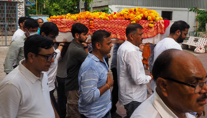Relatives taking body of Air India crash victim for last rites. —AFP