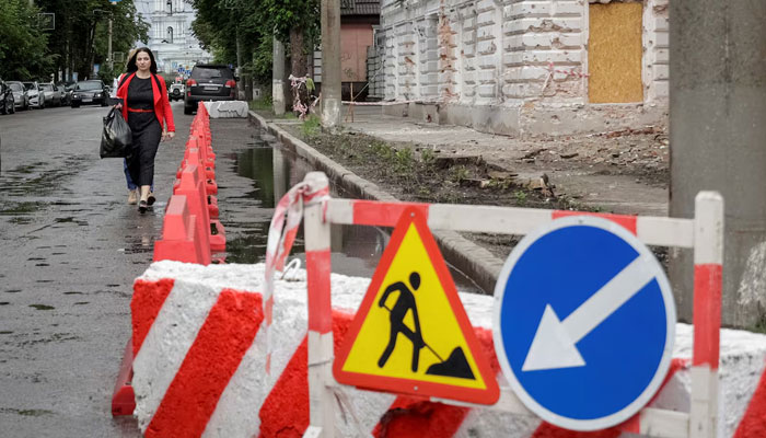 A resident walks at a street near a building damaged by Russian missile strikes, amid Russias attack on Ukraine, in Sumy, Ukraine June 13, 2025. —Reuters