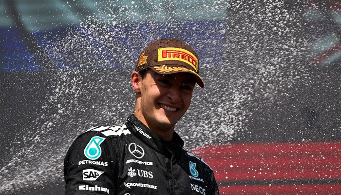 Mercedes George Russell celebrates on the podium with champagne after winning the Canadian Grand Prix, June 15, 2025. —Reuters