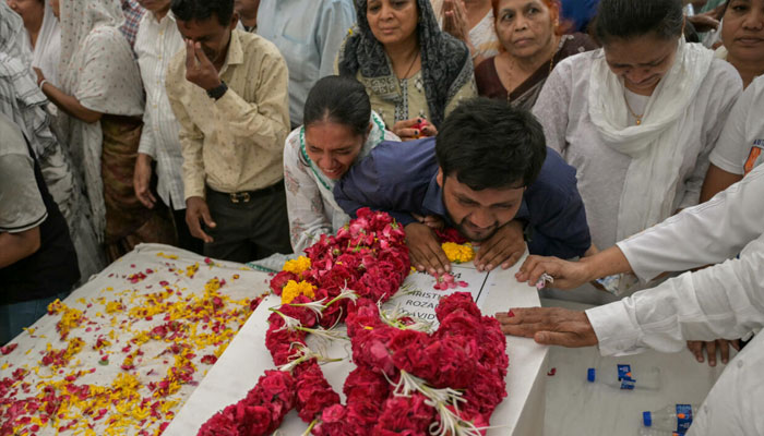 Relatives mourning on the bodies of victims of Ahmedabad crash. —AFP/File