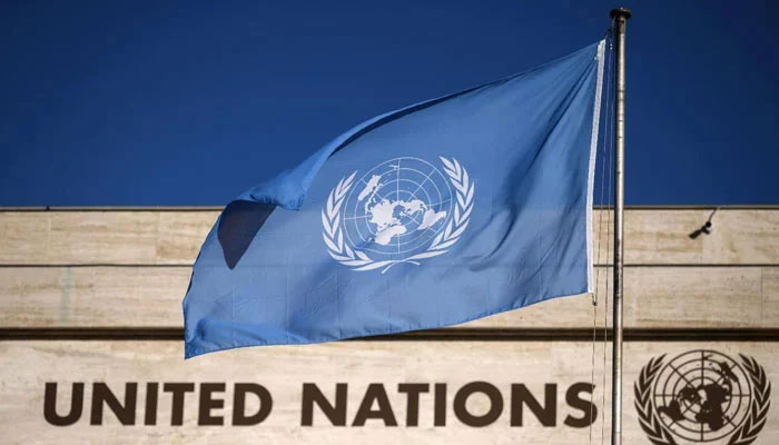 A flag flutters in wind at the main entrance of the building which houses the United Nations Offices in Geneva, Switzerland. — AFP/File