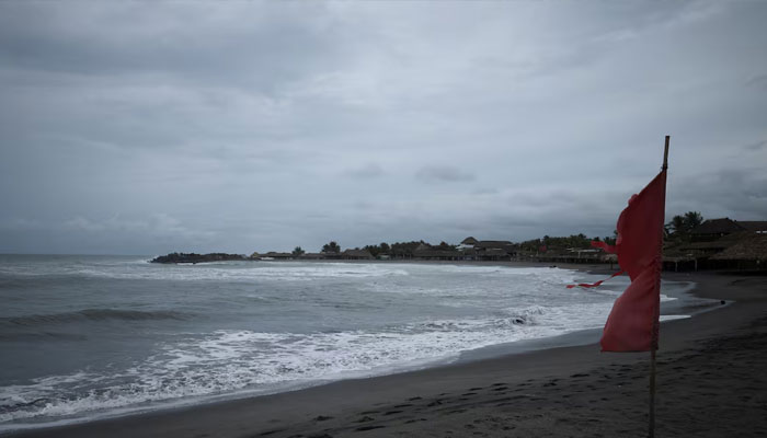A red flag flutters in the wind, warning beachgoers of dangerous conditions as Tropical Storm Erick strengthens off Mexicos Pacific Coast, in San Benito, Chiapas state, Mexico, June 17, 2025. —Reuters