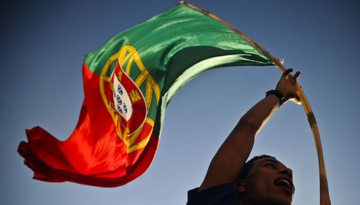 A person waving Portugals national flag. —AFP/File