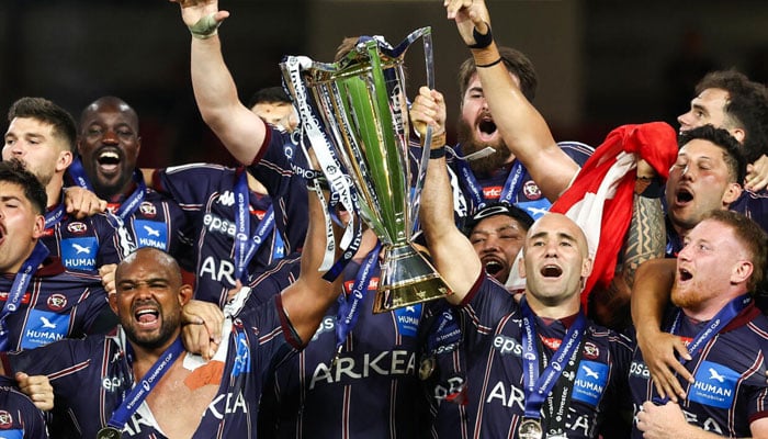 Jefferson Poirot (left) and Maxime Lucu (right) lift the Champions Cup trophy. —AFP/File