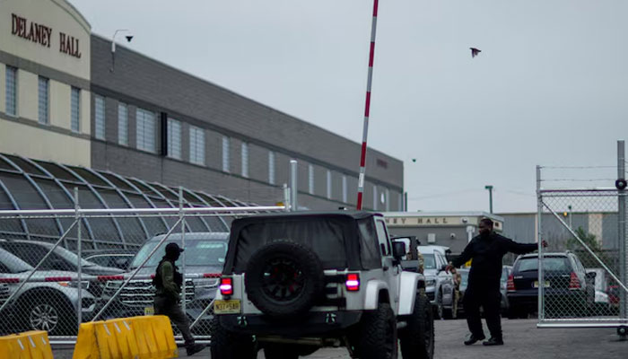 A security worker closes a gate at Delaney Hall, a 1,000-person detention center operated by private prison company GEO Group for Immigration and Customs Enforcement (ICE), in Newark, New Jersey, US, June 18, 2025.—Reuters