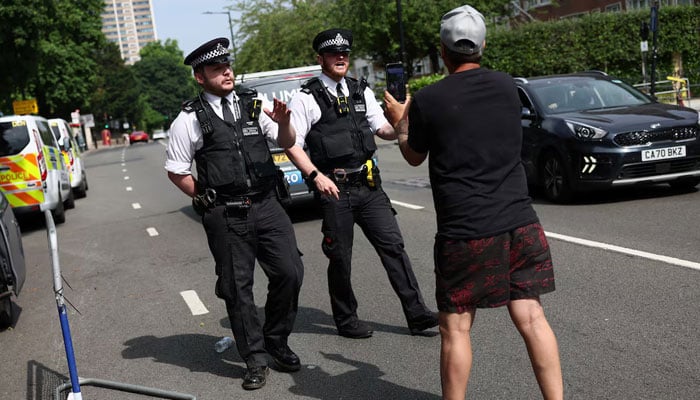 A protester speaks with police as they dismantle their protest, after six men were arrested earlier on the same day on suspicion of grievous bodily harm, near Irans embassy, London, Britain, June 20, 2025. —Reuters