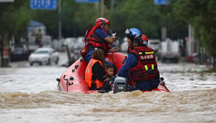 Rescue workers evacuate residents stranded by floodwaters with a boat, following heavy rainfall in Huaiji county of Zhaoqing, Guangdong province, China June 18, 2025. — Reuters