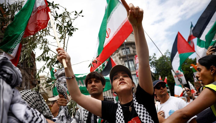 Protestors holding Iran and Palestine flags. —AFP/File