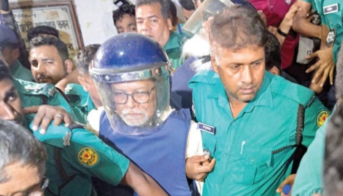 Police personnel escort KM Nurul Huda (centre), Bangladesh’s former chief election commissioner to a court in Dhaka. —AFP/File