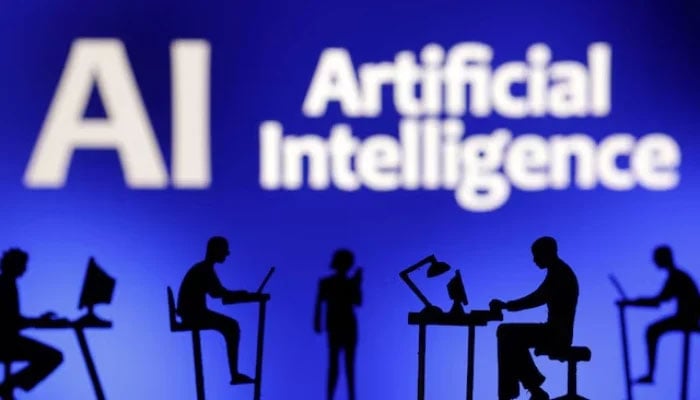 Figurines with computers and smartphones are seen in front of the words Artificial Intelligence AI in this illustration taken, on February 19, 2024. &mdash; Reuters