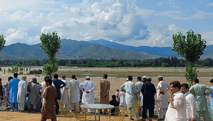 Residents gather, after tourists, who were on a picnic, were swept away by overflowing floodwaters in the Swat River, in Swat Valley on June 27, 2025. — Reuters