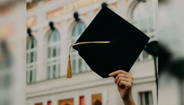 This representational image shows an individual holding a graduation cap. &mdash; Unsplash/File
