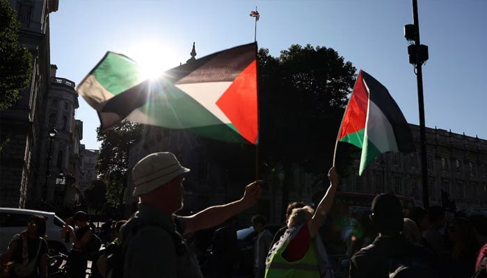 People wave Palestinian flags during a protest after British lawmakers voted to ban pro-Palestinian campaign group Palestine Action as a terrorist organization, outside Downing Street in London, Britain, July 2, 2025. &mdash; Reuters