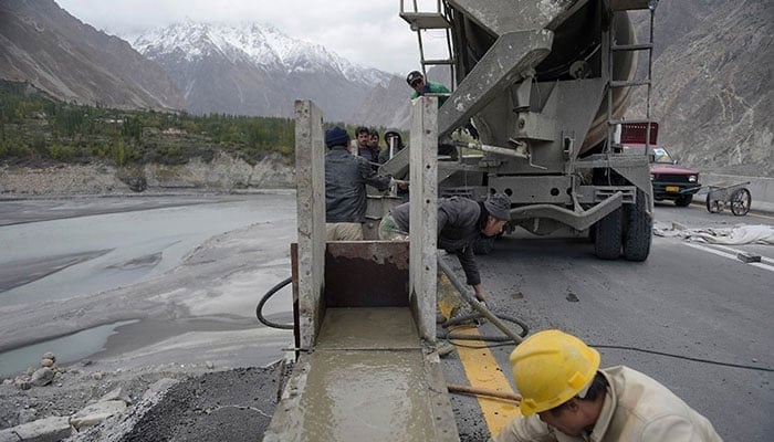 This representational image shows labourers work on the Karakoram highway in Gulmit village of Hunza valley.&mdash; AFP/File