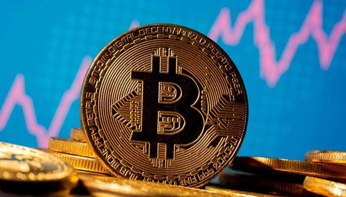 A representation of virtual currency Bitcoin is seen in front of a stock graph in this image taken on November 19, 2020. &mdash; Reuters