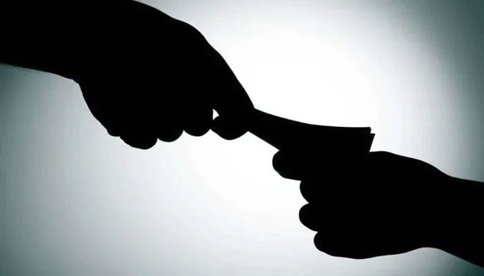 The representational image shows money being delivered as bribery. &mdash; AFP/File