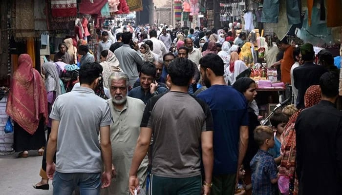 In this picture taken on April 16, 2023, people throng a market area in Lahore. &mdash; AFP