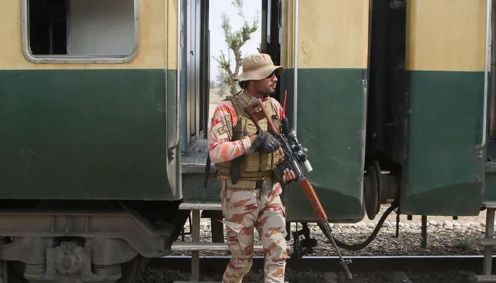 A soldier stands beside a train bogey in Balochistan. — Reuters/File