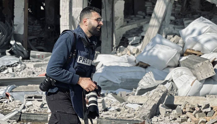 Palestinian photographer Motaz Azaiza looks on as he covers Israels war on Gaza. — X/@azaizamotaz9/File