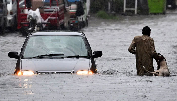A car wades through a flooded street during heavy monsoon rains in Rawalpindi on July 17, 2025. — AFP