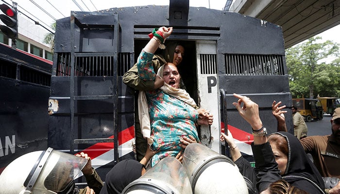 A PTI chants slogans while being detained by police officers during a nationwide protest demanding Imran Khans release on the second anniversary of his jailing, in Lahore on August 5, 2025. — Reuters
