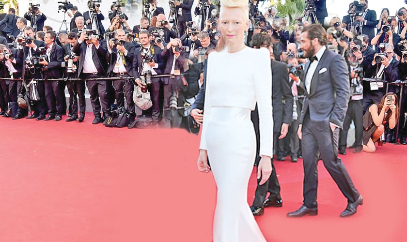 Tilda Swinton stood tall and strong in a sleek white gown by Haider Ackerman.