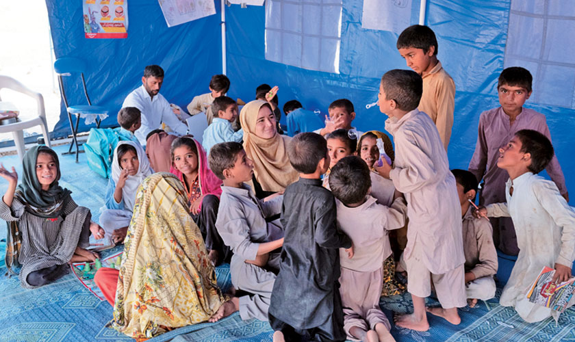 Reema Jaanwari, IRC Child Facilitator with children at the Early Childhood Education (ECE) in Model Town Camp Play-based learning for 5-10 year olds.