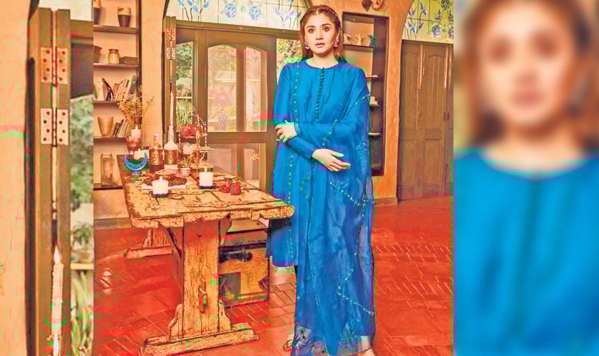 Hand embroidery and mirror work go along the panels of a teal blue raw silk canvas, with buttons on the shirt and sleeves. A matching organza dupatta is trimmed and embellished with mirror work and embroidery, as well as patchwork in appliqué. To complete the look, pair with matching cigarette pants.