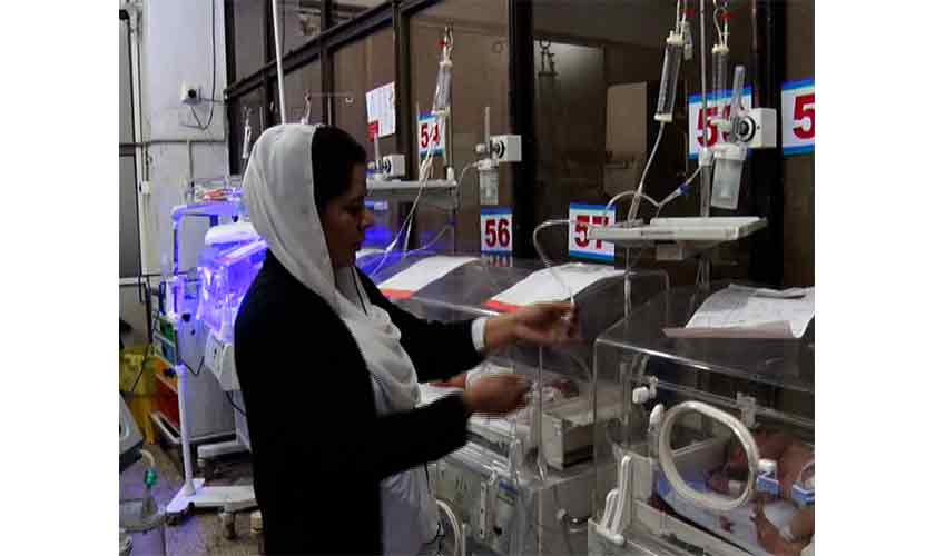 A nurse inquires about the health of a child lying in an incubator at Lady Reading Hospital in Peshawar.
