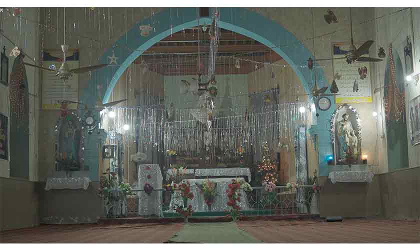 Sparkly: Bells, garlands and wreaths, fairy lights, flowers and tassels decorate a church ahead of Christmas Day in Faisalabad.