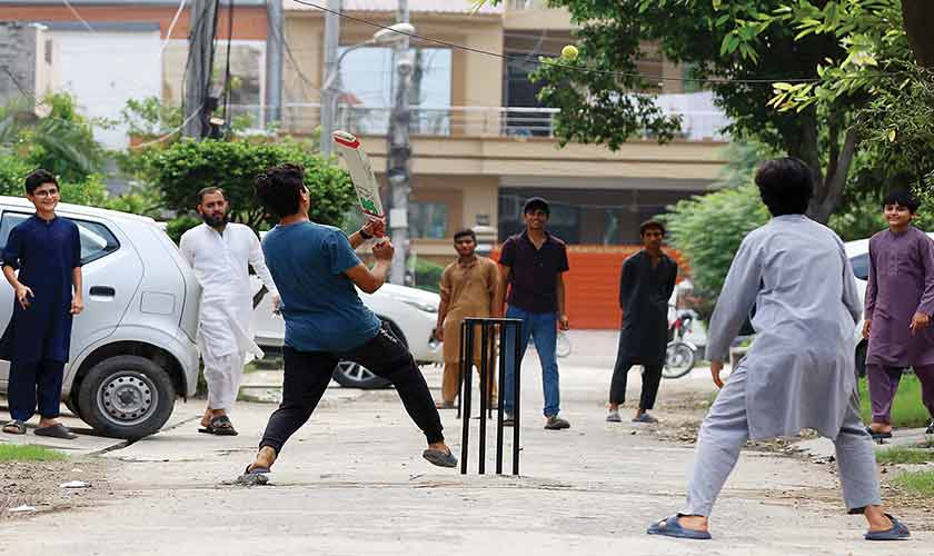 On a rooftop you learn to negotiate around a clothesline and a satellite cable; in the gully you learn to time your run between a passing rickshaw and a parked bicycle. The practice is its own quiet magic. — Photo by Rahat Dar