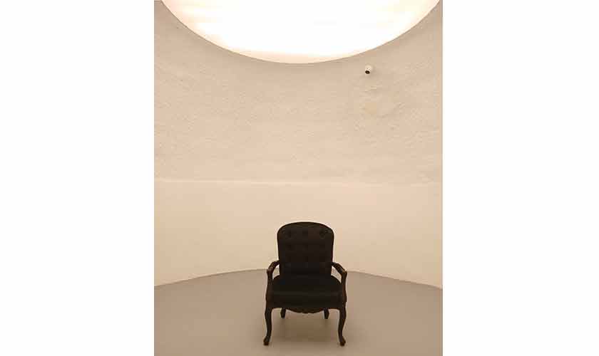 A chair with hidden push button connected to a light source