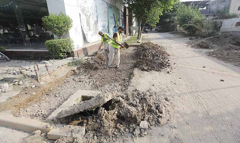 The remodelling of walkways in Gulberg is being carried out by the LDA as part of its Sustainable Development Model scheme. — Photos by Rahat Dar