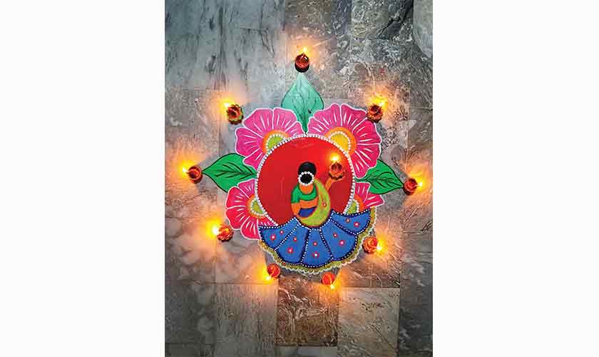 An image of a rangoli; a decorative design made with coloured sand that symbolises prosperity, fortune andhappiness.