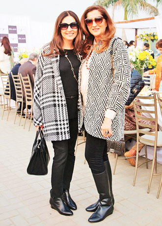 Old friends Aamna Taseer and Anila Shah keep it comfortable and coordinated with jackets in the classic monochromatic black and white. Jeans and shades complete the daytime look - simplicity works best, especially when Burberry and Chanel are involved.