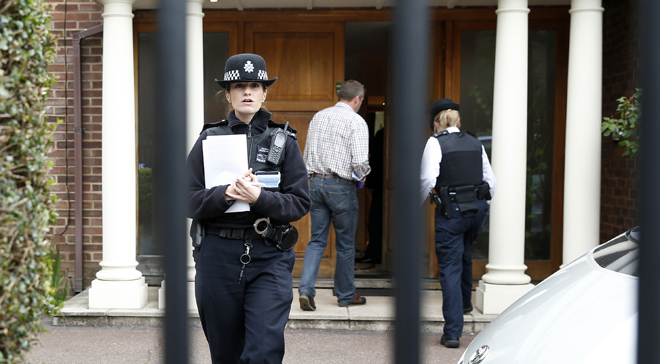 British police stand guard outside the house of Altaf Hussain in London.