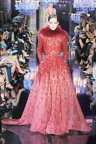 Elie Saab Shining Swarovski crystals and glowing pearls were illuminated by nine chandeliers over the catwalk, lending Elie Saab's Fall 2014 outing an ethereal shine. There was hardly a dress that wasn't illuminated and while Saab's designs are never really fashion forward, they do excel in creating a brand of well-designed, expensive couture that his wealthy clients love. 