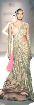 Gaurav Gupta's collection was big on lace sleeves that looked feminine and sexy. The designer also played around with interesting ideas such as an asymmetrical look that featured an electric blue one-sleeved gown and embellished arm gloves that added oomph to a gold sari.