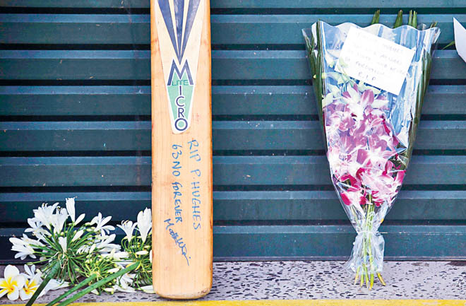 Messages and flowers of tribute to Australian cricketer Phillip Hughes can be seen outside the main gates to the Sydney Cricket Ground