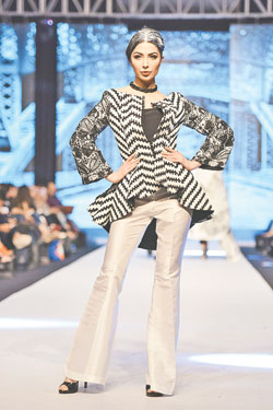 Adnan Pardesy Collection: Labyrinth Technically, a Labyrinth is a maze with complex branching and that's the ethos that directed the path of Adnan Pardesy's new collection. He's a designer who loves fabric, weaving and creating patterns as he plays with it. If there were a Bottega Veneta in Pakistan, Pardesy would be the designer behind its intrecciato leather weaves. One can only hope that Adnan Pardesy will also manage to put his techniques into more utilitarian and wearable avenues, allowing those who appreciate his skill to access and enjoy it. Key trends: Very clearly monochrome, this collection focused on jackets, short cropped waist-coats and full bodied coats for men.  