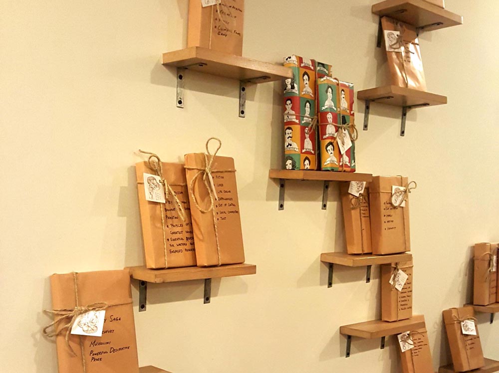 You pause, trying to decipher what lies veiled in plain brown paper. Well, there are hints, handwritten on the wrapped books, regarding their genre. 