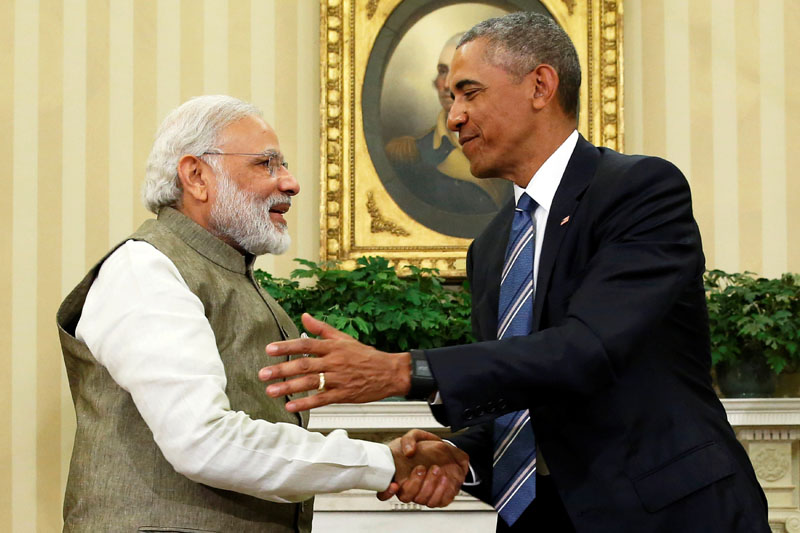 Obama (R) shakes hands with India's PM Modi. -- Courtesy Reuters