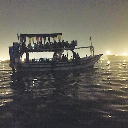The serene midnight boat ride is a stark contrast to the bustling buzz of the city.