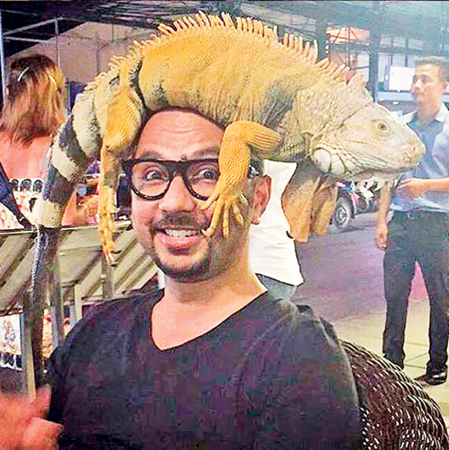Not your average selfie: Nomi Ansari shows us how the ultimate travel selfie is taken. Instead of taking pictures of beautiful sunsets and the beaches of Koh Samui, Thailand, Nomi chooses to put an iguana on his head. 