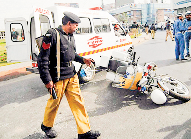 Deadly attack: A policeman inspects a police motorcycle after the terrorist attack in Lahore on March 3, 2009