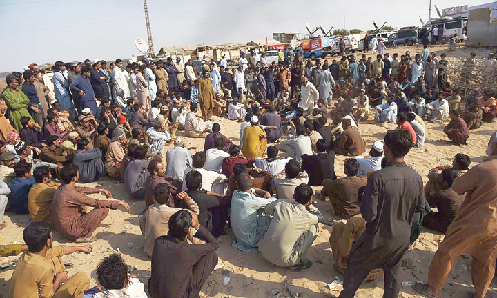 Labourers gather following explosion at Gadani.