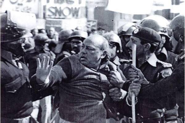 Jalib being manhandled at a protest.